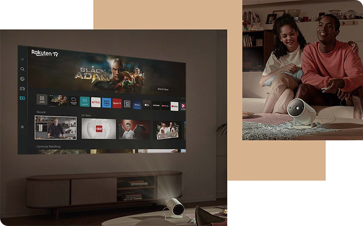 Projektor The Freestyle wy&sacute;wietla na &sacute;cianie ekran z aplikacjami Smart TV. Po drugiej stronie siedz&aogon; dwie osoby. 